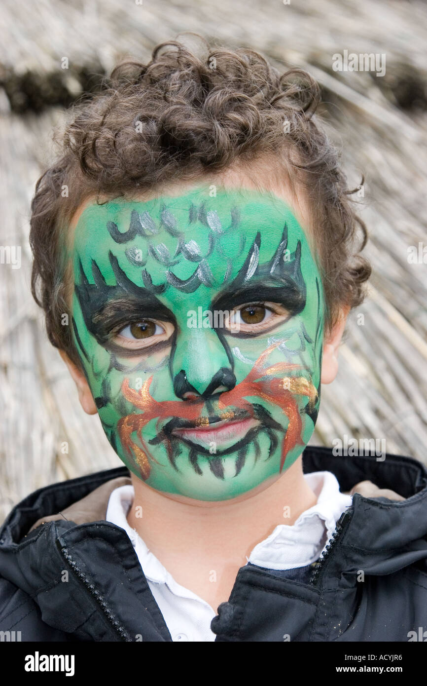 Little boy wearing dragon face paint Stock Photo Alamy