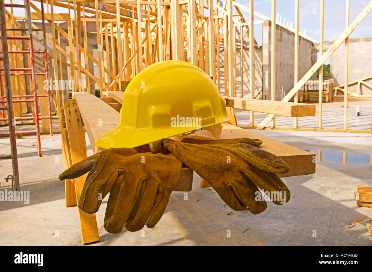 lumber stacked up at construction site for home building Stock Photo
