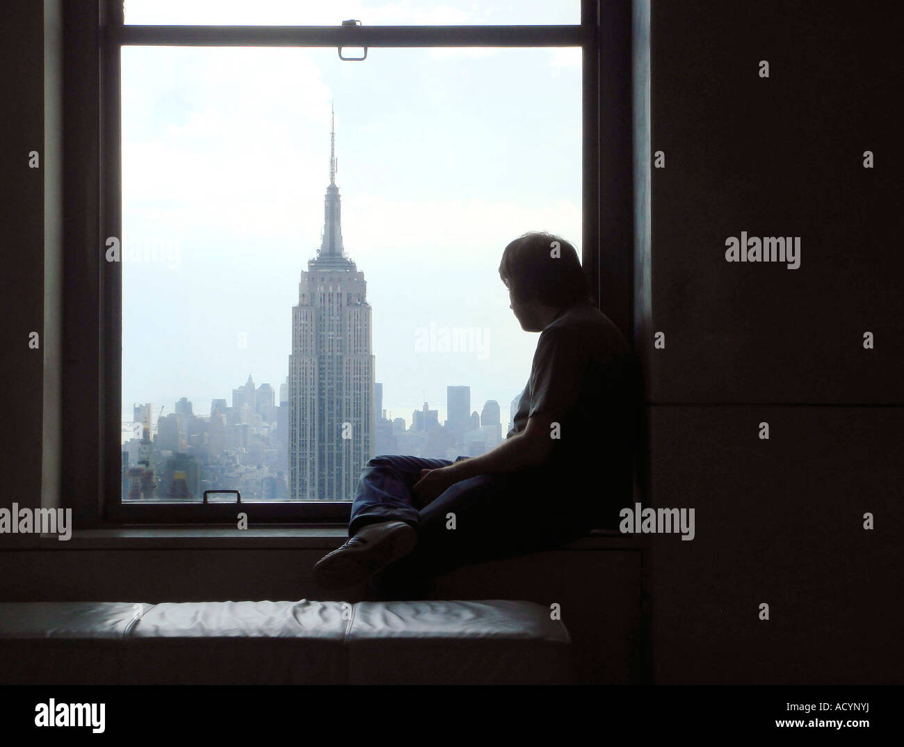 Man looking towards the Empire State Buidling from the Rockefeller Building Manhattan New York Stock Photo
