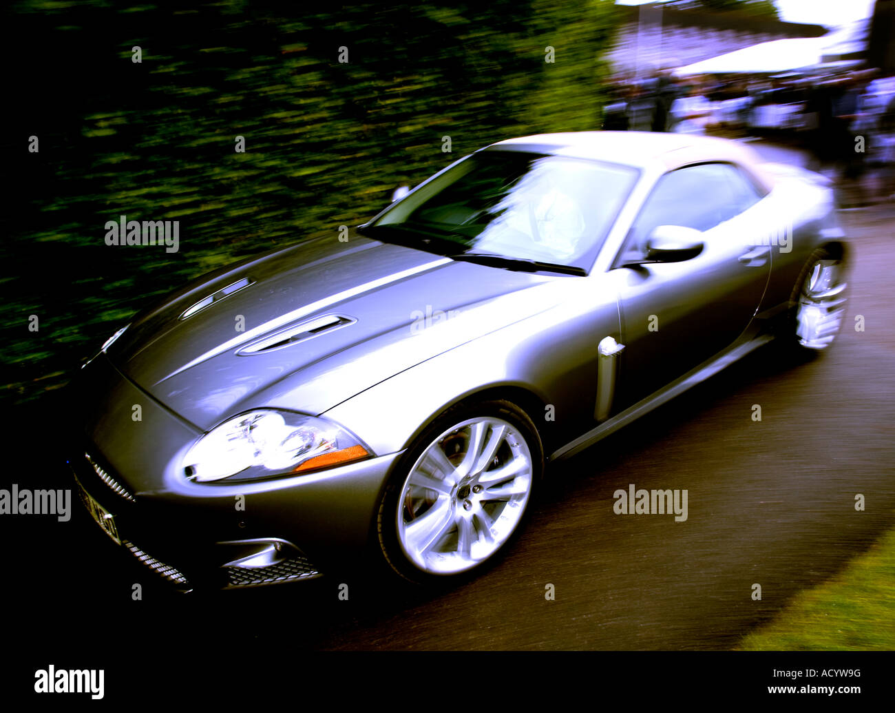 2007 Jaguar XKR leaves the paddock area at Goodwood Festival of Speed, Sussex, UK. Colour toned. Stock Photo