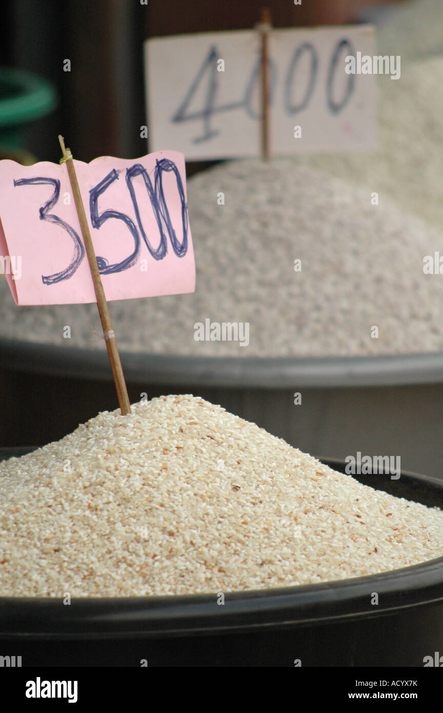 Tubs of rice, with a price tag in Lao kip, are displayed in a market in Luang Prabang, Laos. Stock Photo