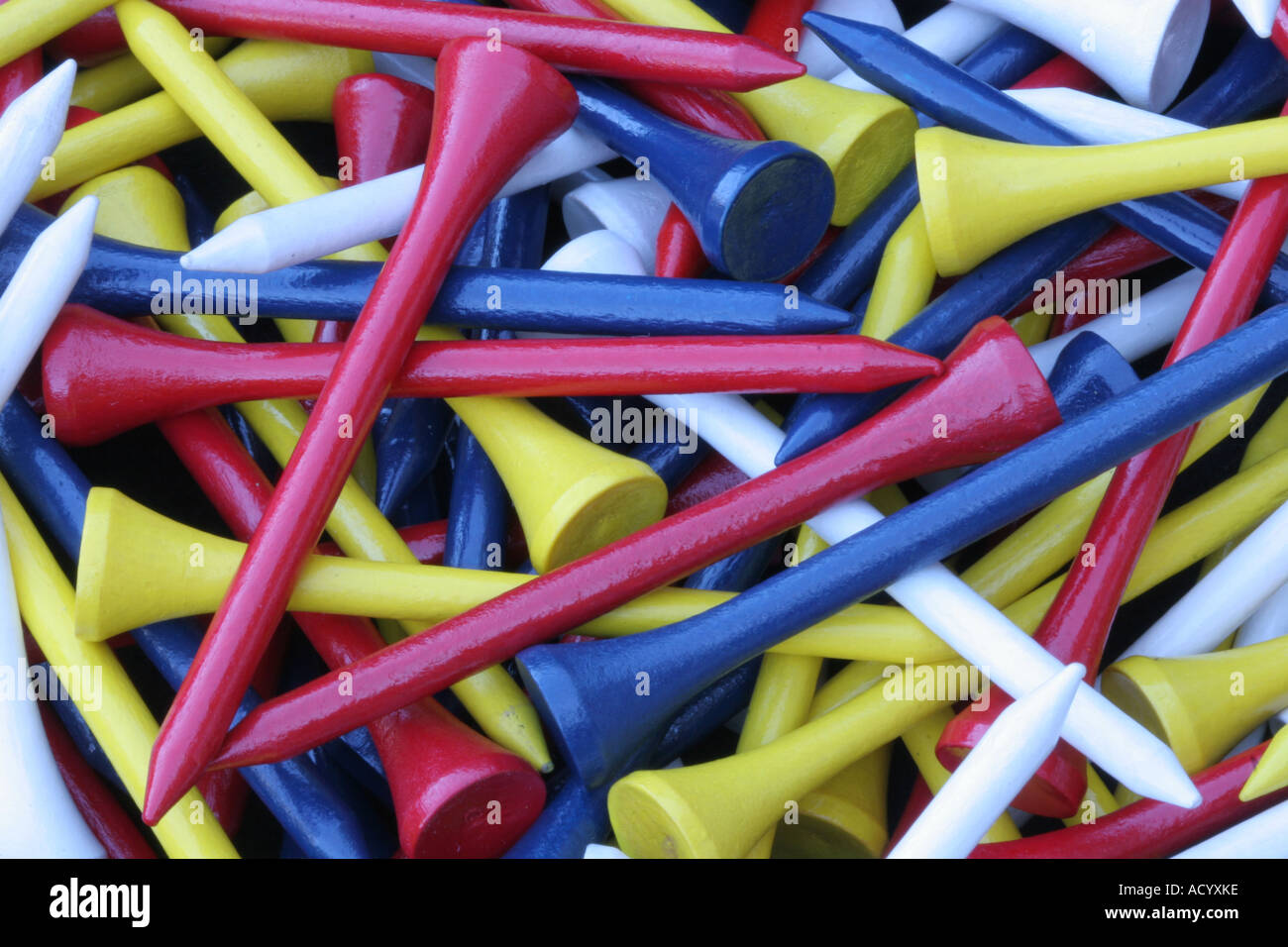 Pile of colourful wooden golf tees red yellow blue white hires stock