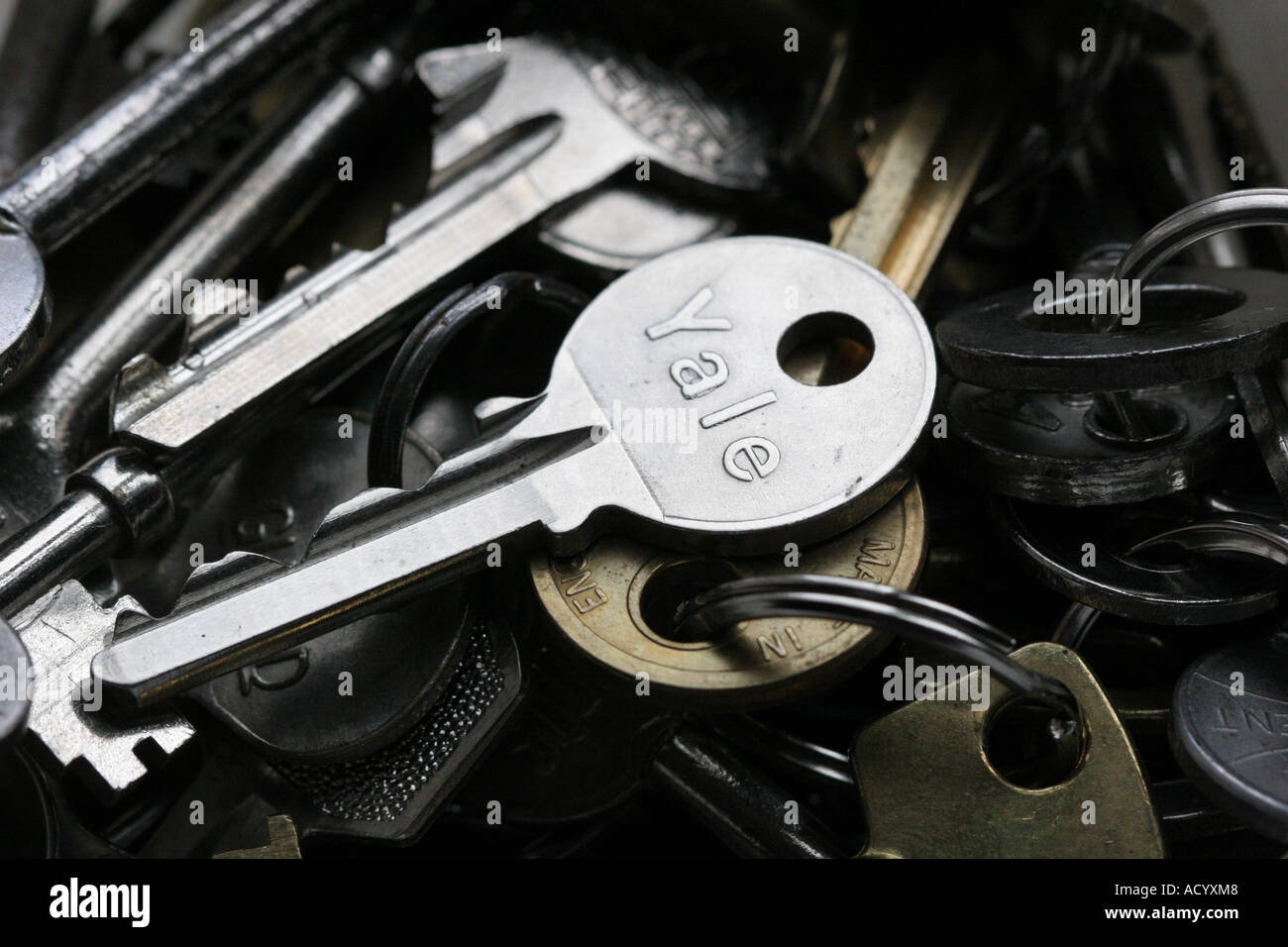 pile of keys including a yale key Stock Photo