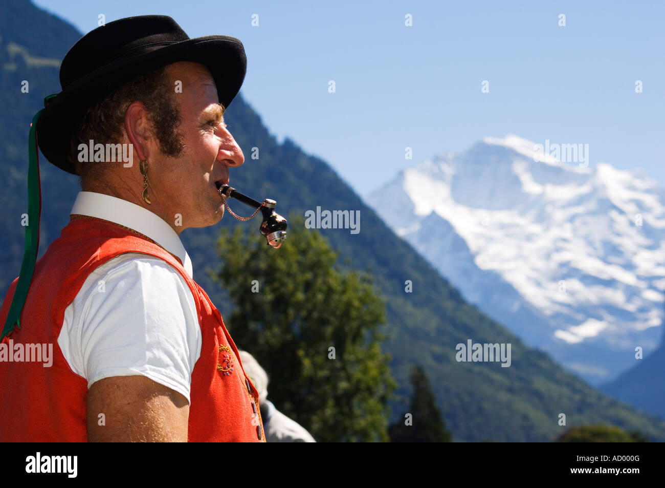 A Swiss Man Smoking a Pipe in Traditional Alpine Costume at the