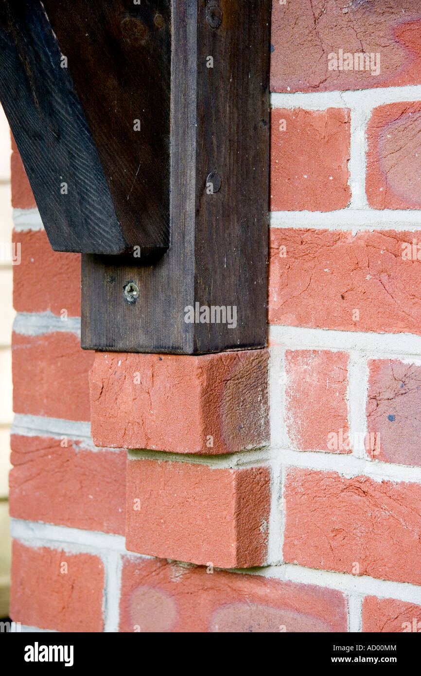 Corbelling used as a support for a wooden beam in a brick wall Stock