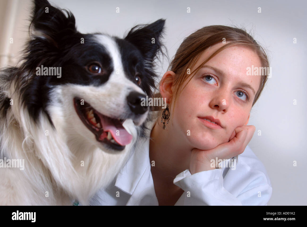 A YOUNG FEMALE VETERINARY SCIENCE STUDENT GIVING A HEALTH CHECK UP TO A