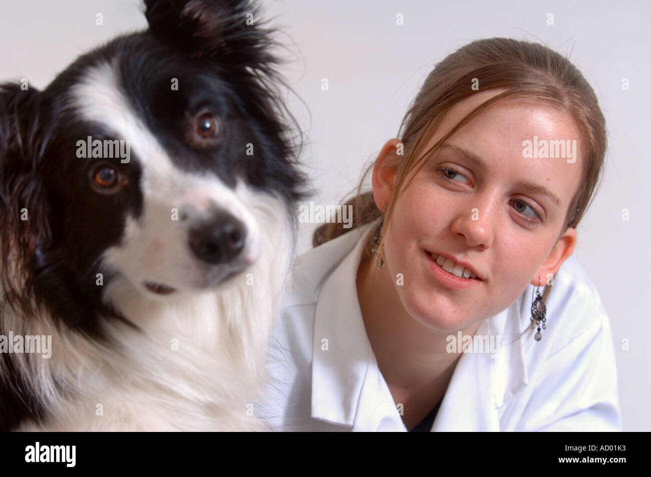 A YOUNG FEMALE VETERINARY SCIENCE STUDENT GIVING A HEALTH CHECK UP TO A