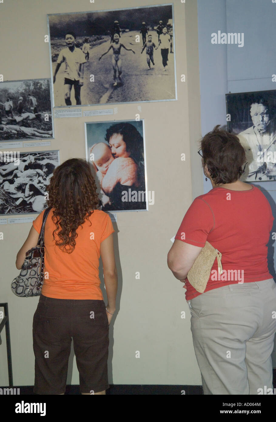 People looking at pictures of war atrocities inside the War remnants Museum 'Ho Chi Minh City' Vietnam Stock Photo