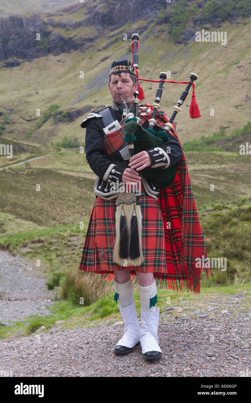 Piper playing bagpipes at Glencoe Highlands Scotland Stock Photo