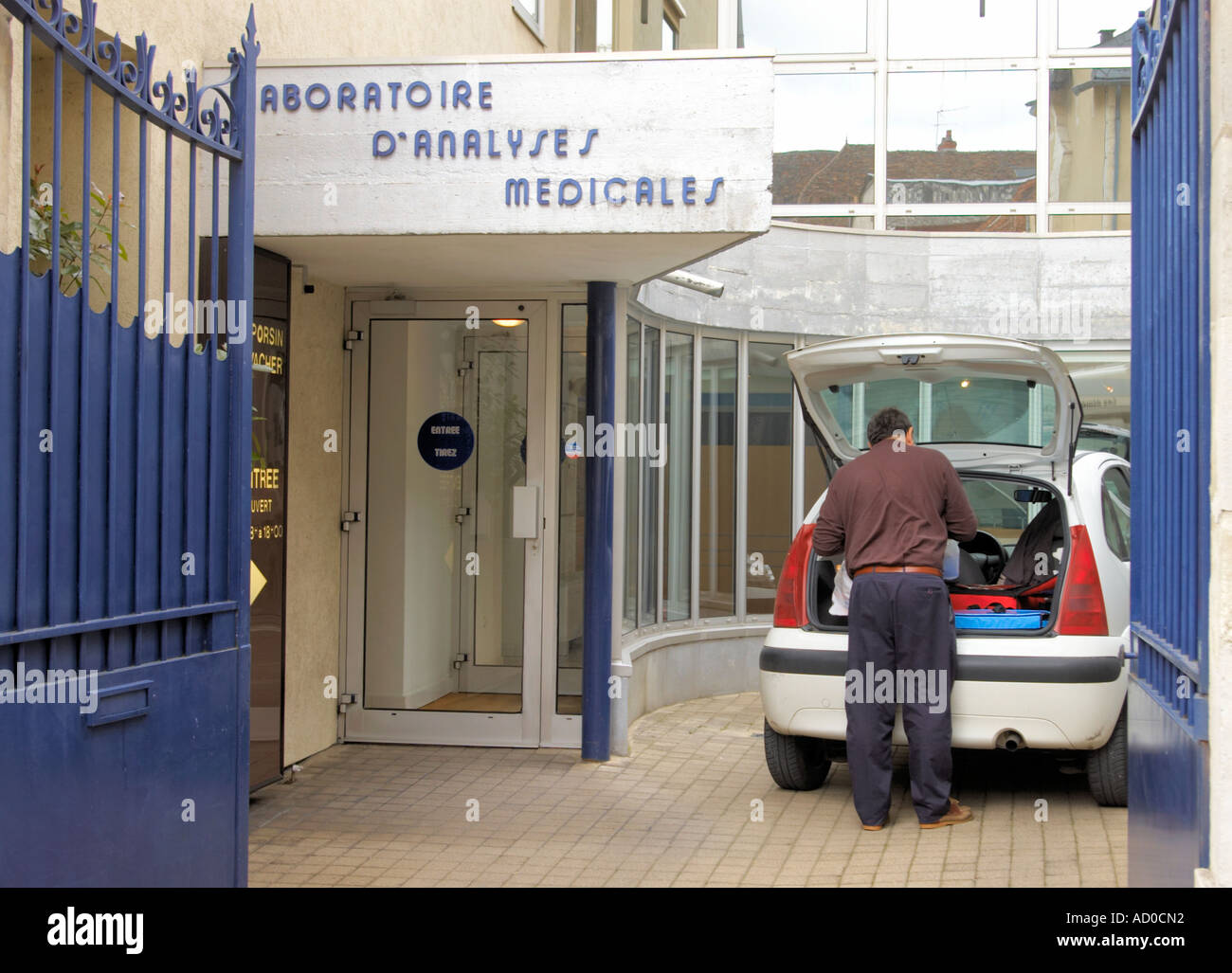 man unloading medical samples at a clinic in Bourges in France Laboratoire s Analyses Medicales Stock Photo