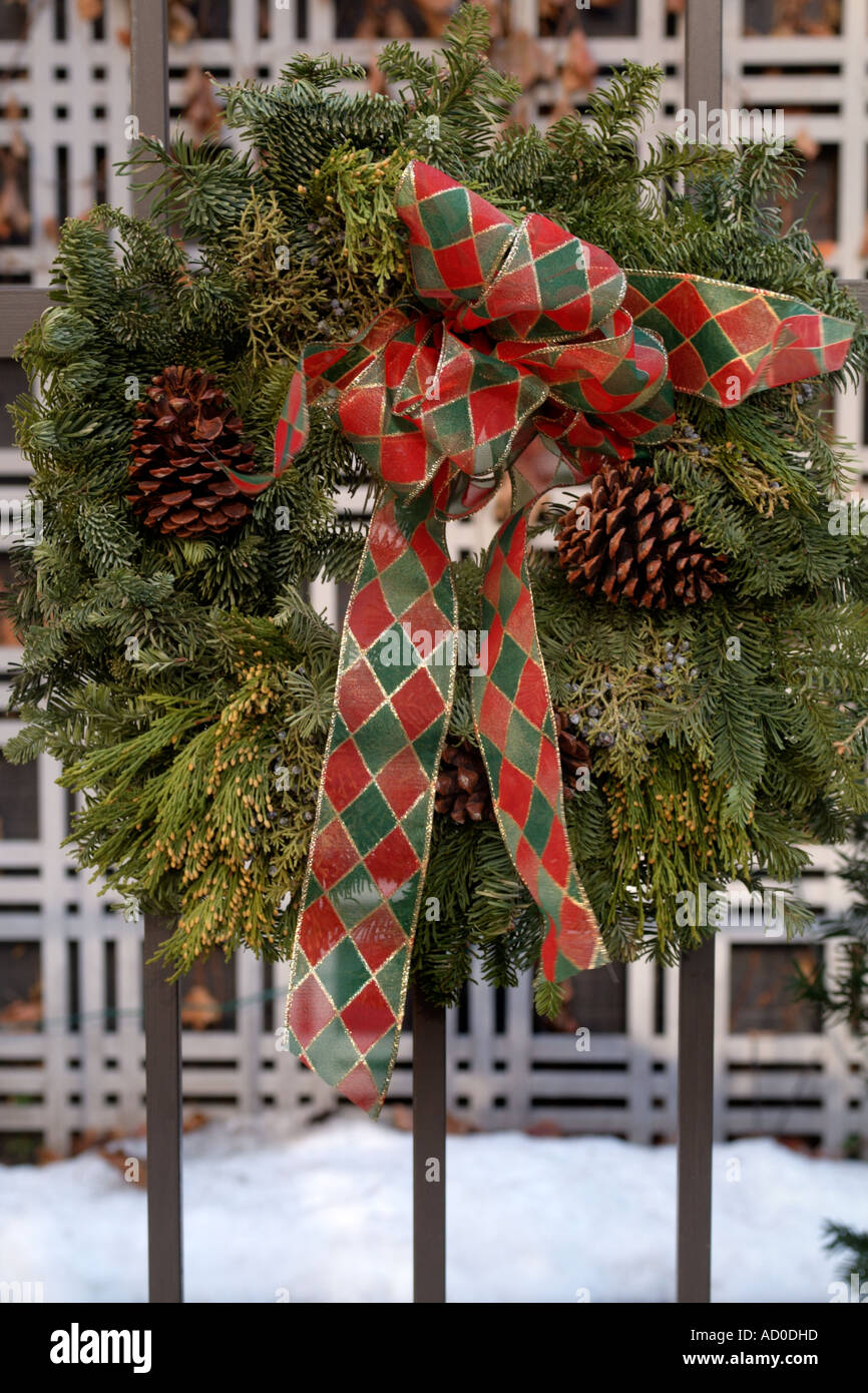 Christmas Wreath with Red Checked Ribbon and Pine Cones on Building ...