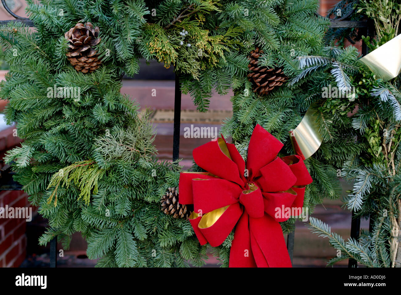 Christmas Wreath with Red Ribbon and Pine Cones on Building Gate Stock ...
