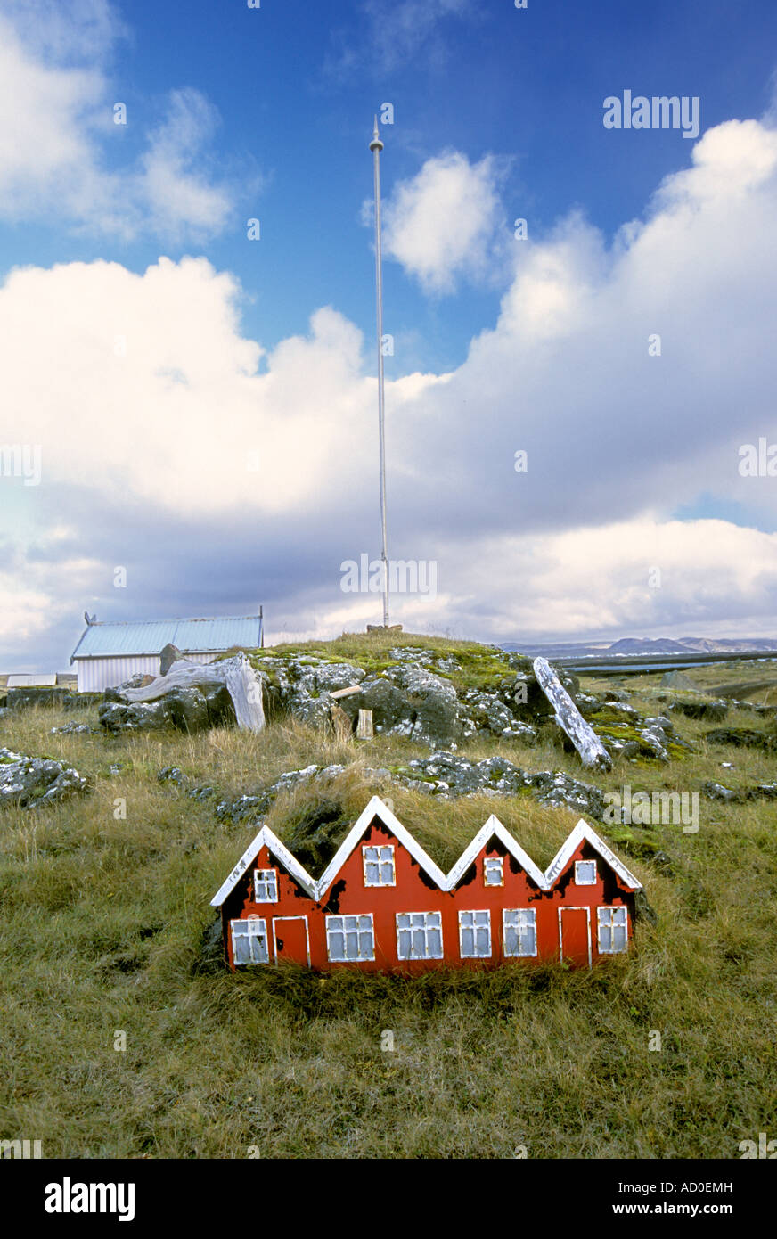 Near Keflavík Iceland A miniature house sits in front of a radio tower Stock Photo