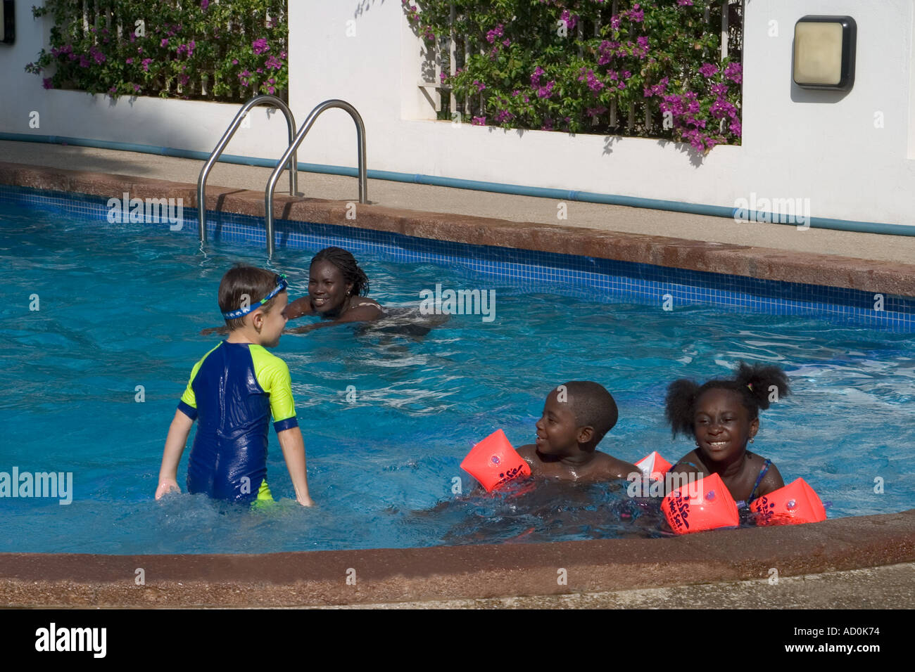 Children from different ethnic backgrounds swimming and playing at a
