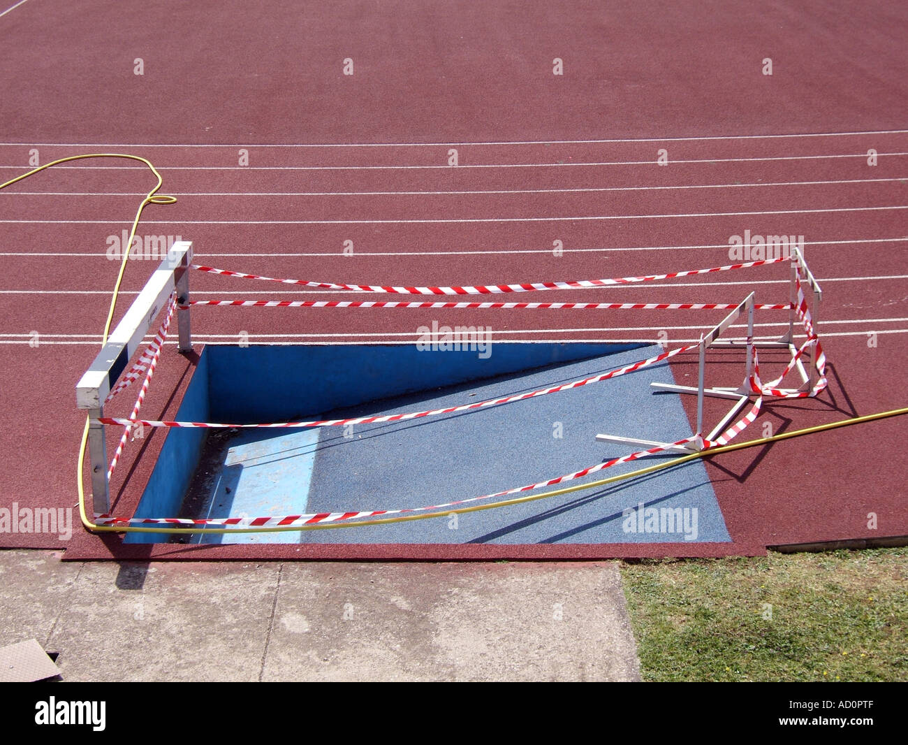 steeplechase hurdle water pit blocked with red and white tape Stock