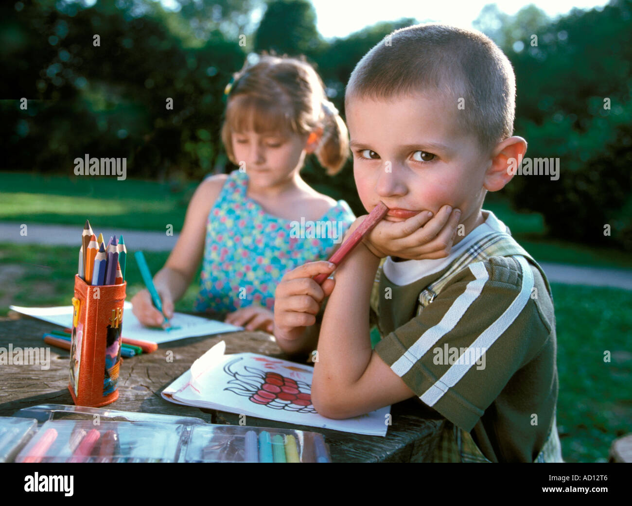 girl drawing and boy thinking Stock Photo - Alamy