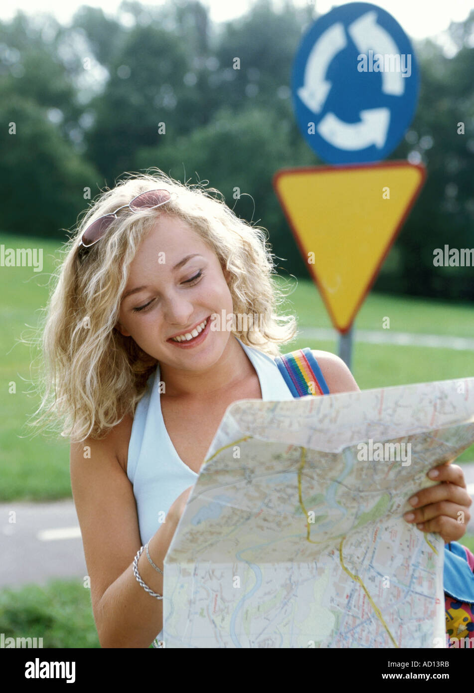 Woman smiling reading map hi-res stock photography and images - Alamy