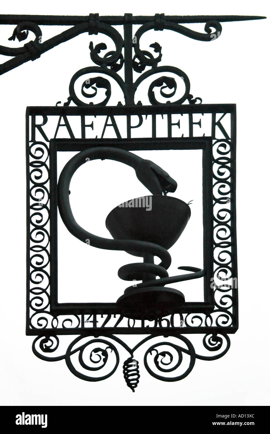 Vertical close up of an old fashioned wrought iron sign hanging outside a pharmacy. Stock Photo