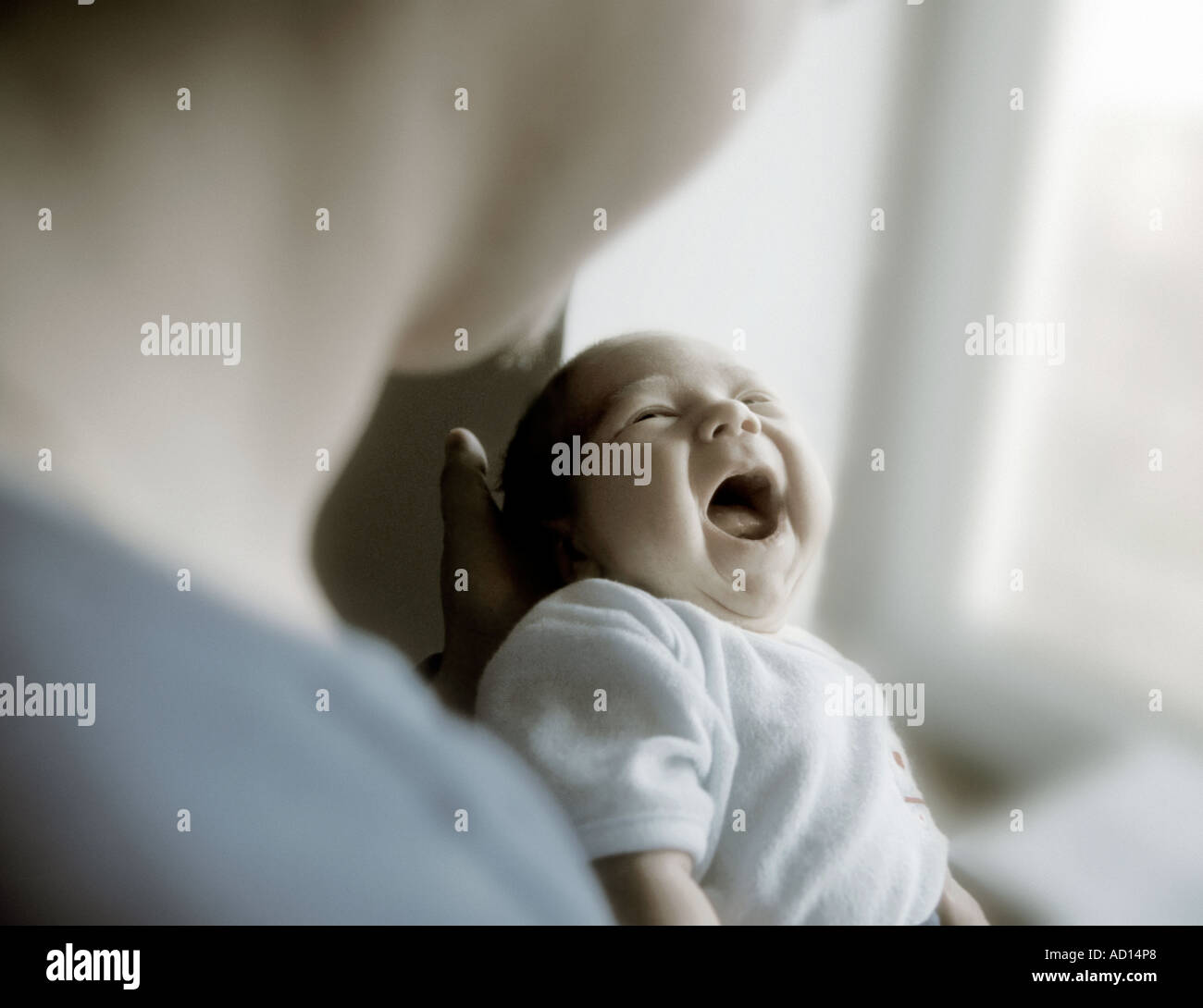 infant boy held by father Stock Photo
