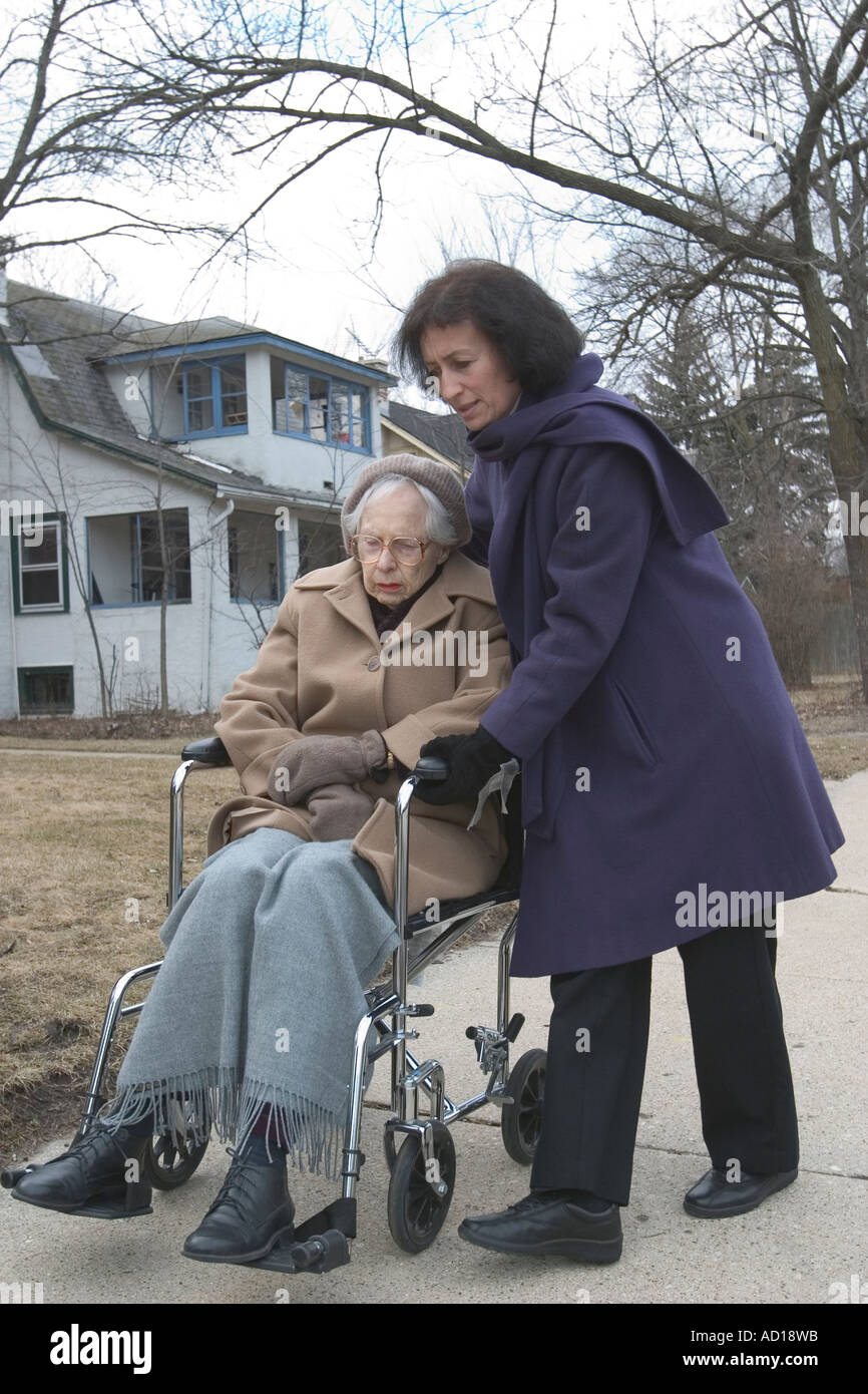 Ninety year old woman out for some air with her daughter-in-law on a winter day near Chicago Illinois Stock Photo