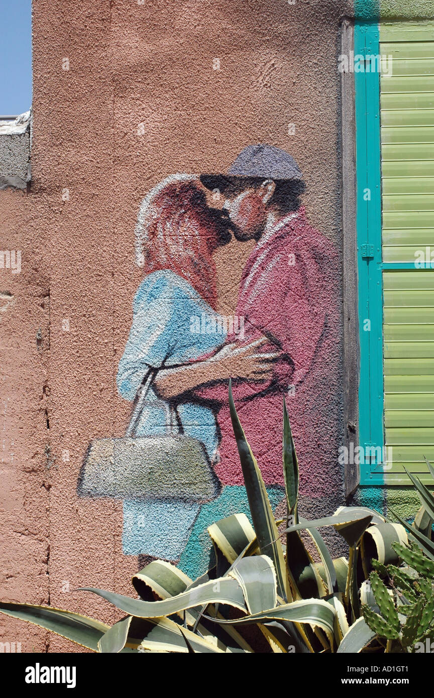Graffiti wall painting of a young men and woman having fun Stock Photo