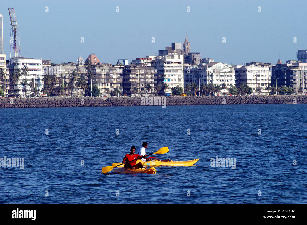 Two men canoeing in Arabian sea off Marine Drive in Bombay now Mumbai Maharashtra India Stock Photo