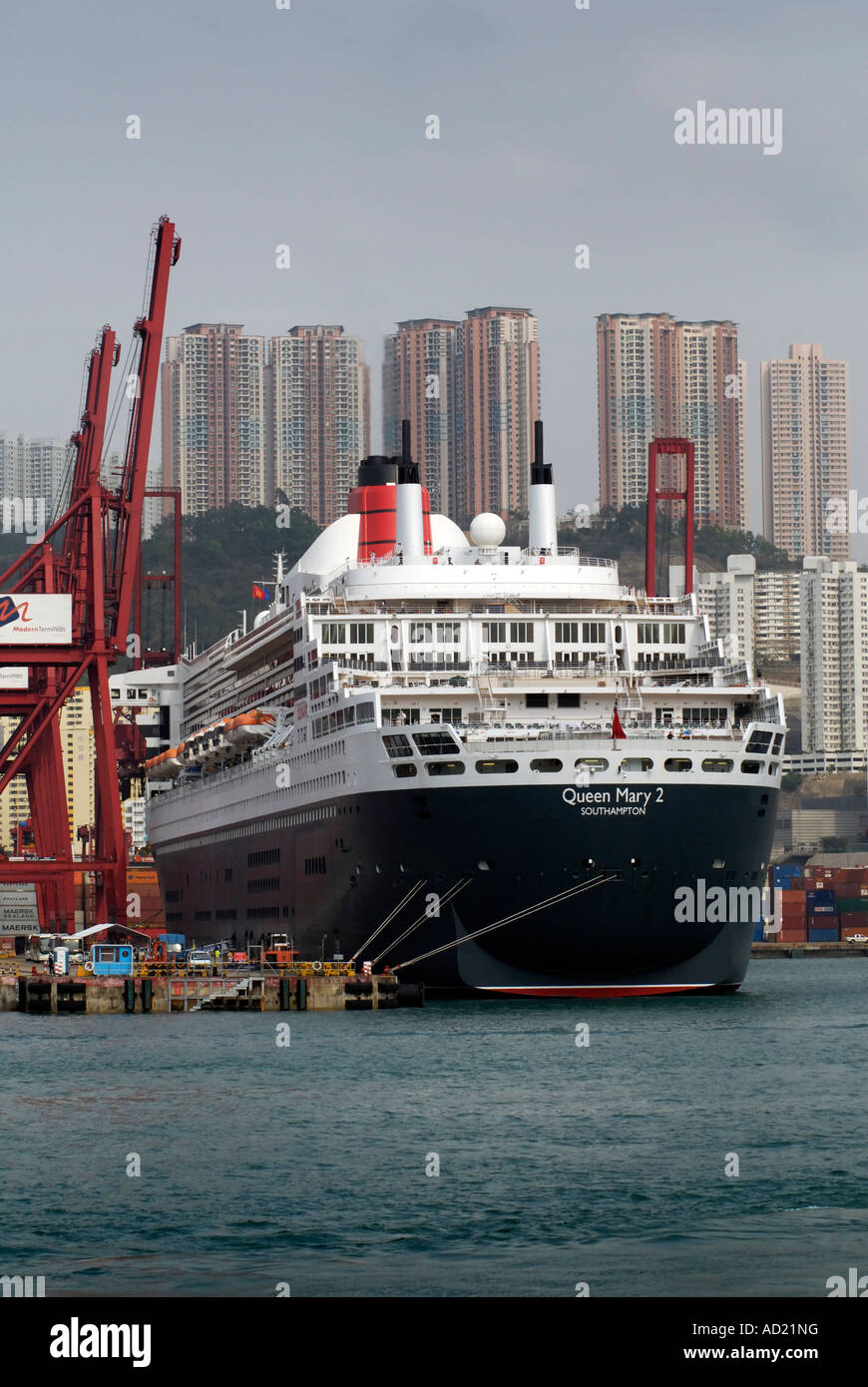 The Queen Mary 2 docked at a container terminal in Hong Kong Stock
