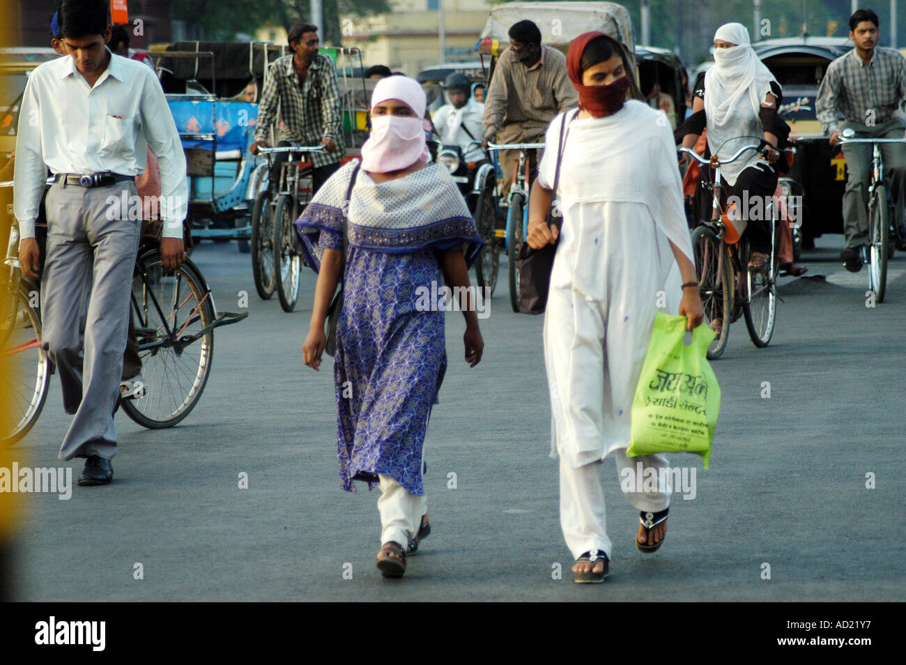 Two women cover their faces with scarf to avoid heat during the summer season, Nagpur city, Maharashtra, India Stock Photo