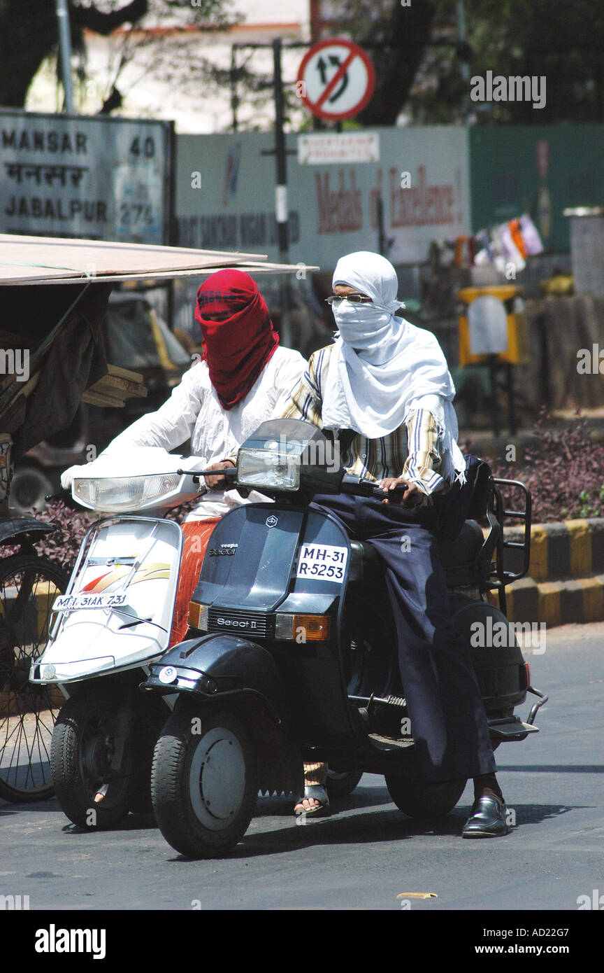 ASB73153 Two wheeler motor bike riders cover their faces with scarf to avoid summer heat at Nagpur Maharashtra India Stock Photo