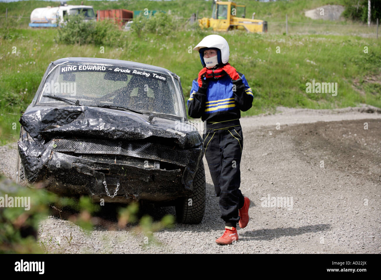 A battered Folkrace banger racing car and driver on the side of the ...