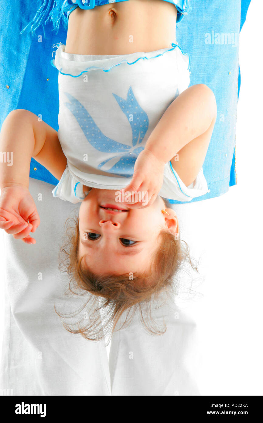 child of one a half years is enjoying being held upside down - Model Release Number 593 Stock Photo