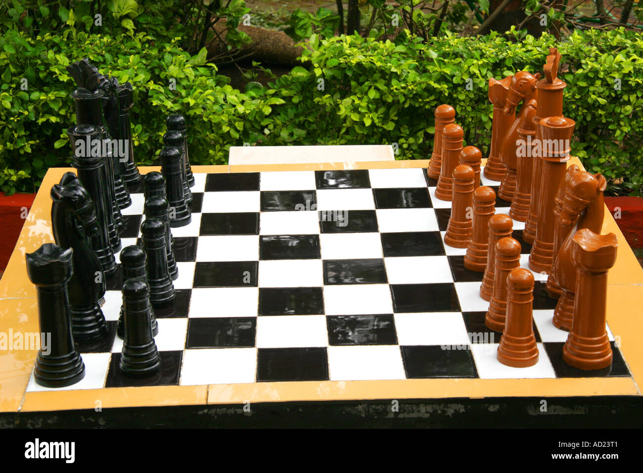 Chess Board with playing pieces, the chess board is made of ceramic tiles and pieces of wood, India Stock Photo