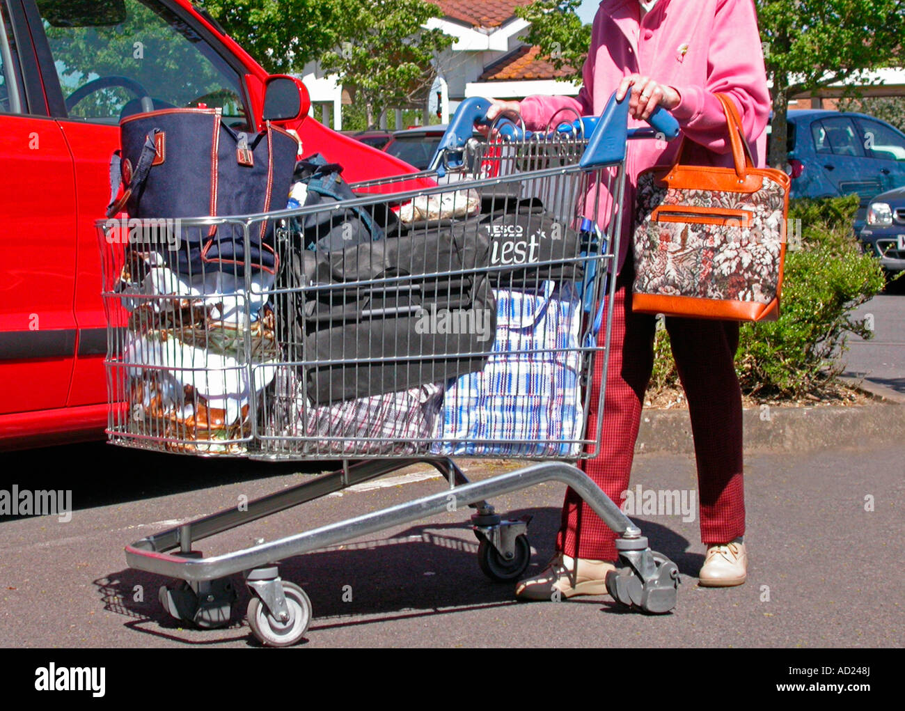 Old woman shopping pushing trolley hires stock photography and images