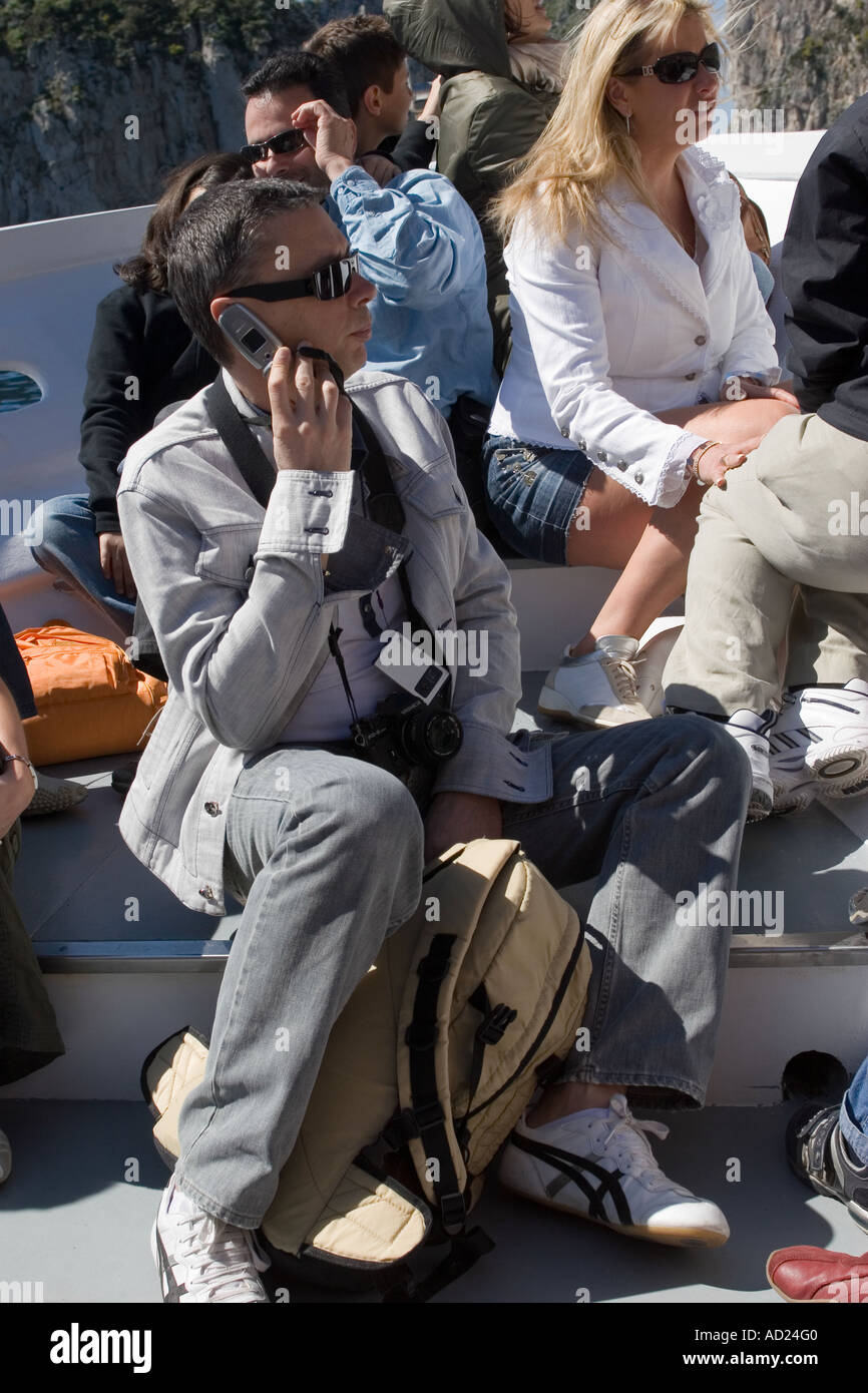 Man Using Mobile Phone on Cruise around the Island Capri Italy Stock Photo