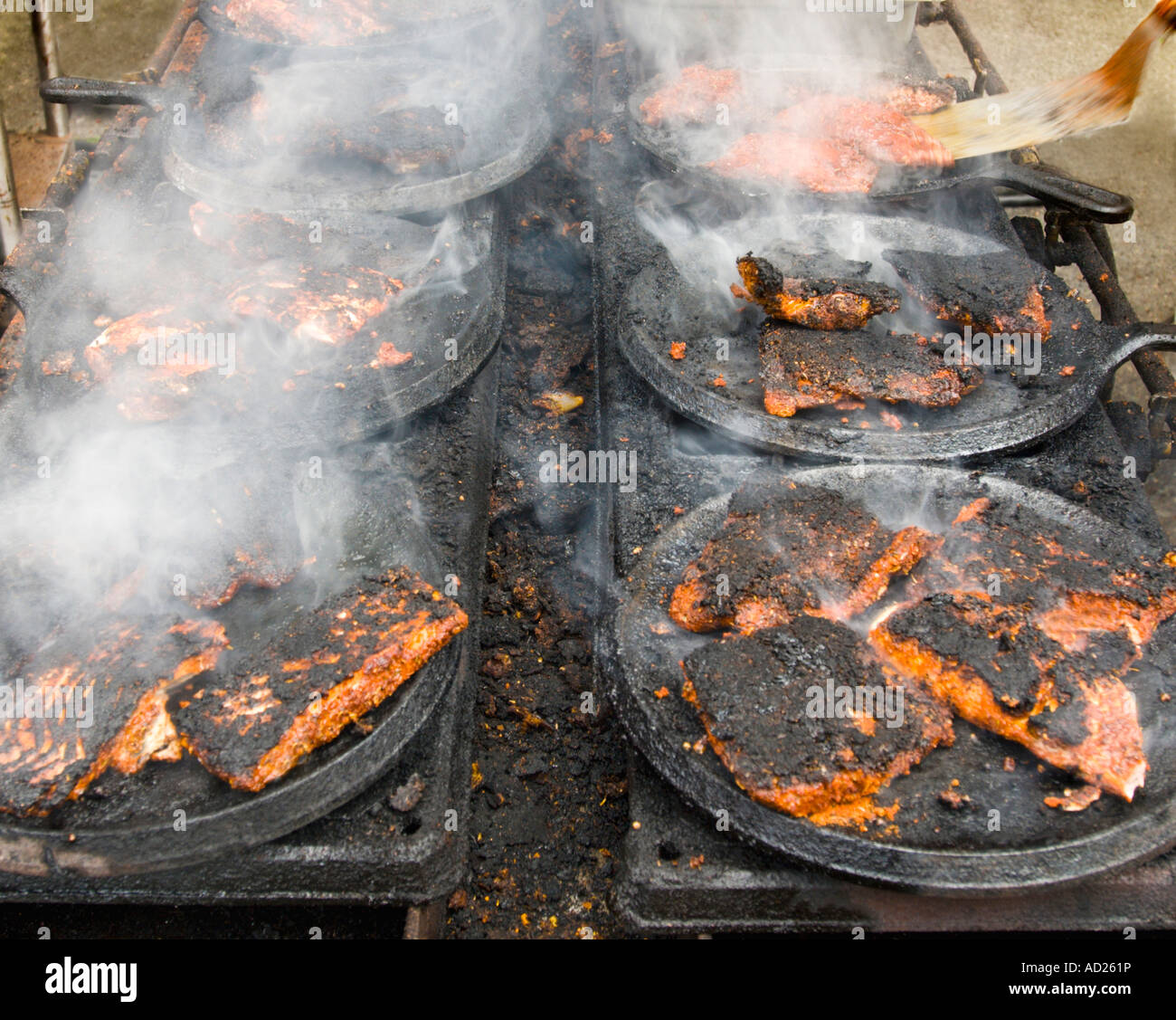 fried salmon steaks cooking in frying pans Stock Photo