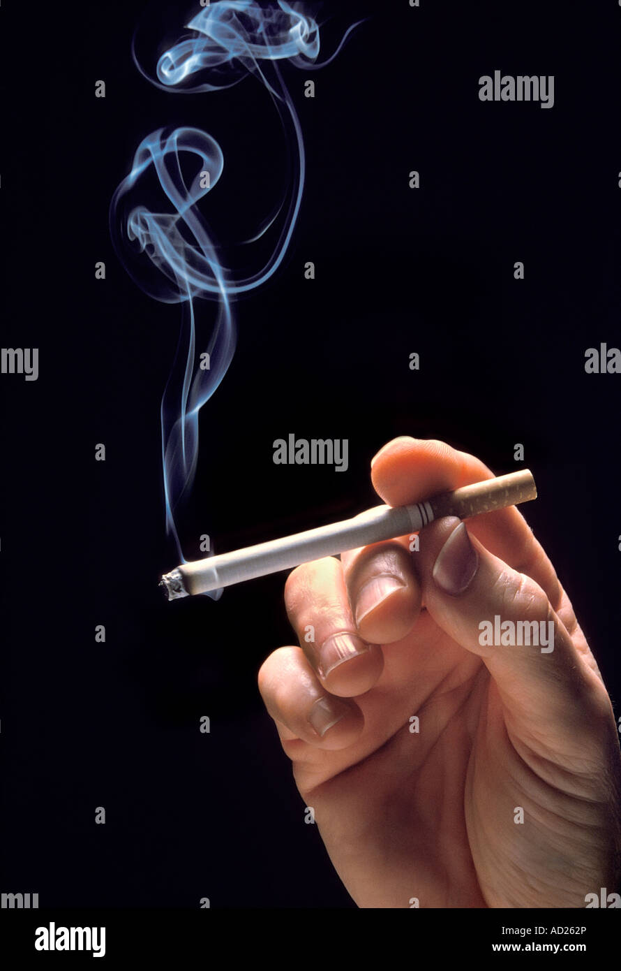 hand holding lighted cigarette Stock Photo
