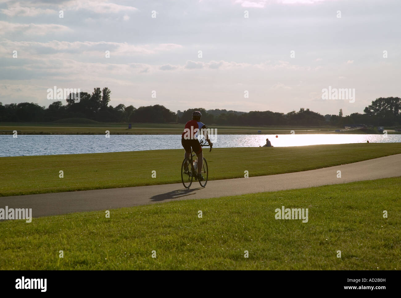 Cyclist riding into the sun on a summers evening Stock Photo