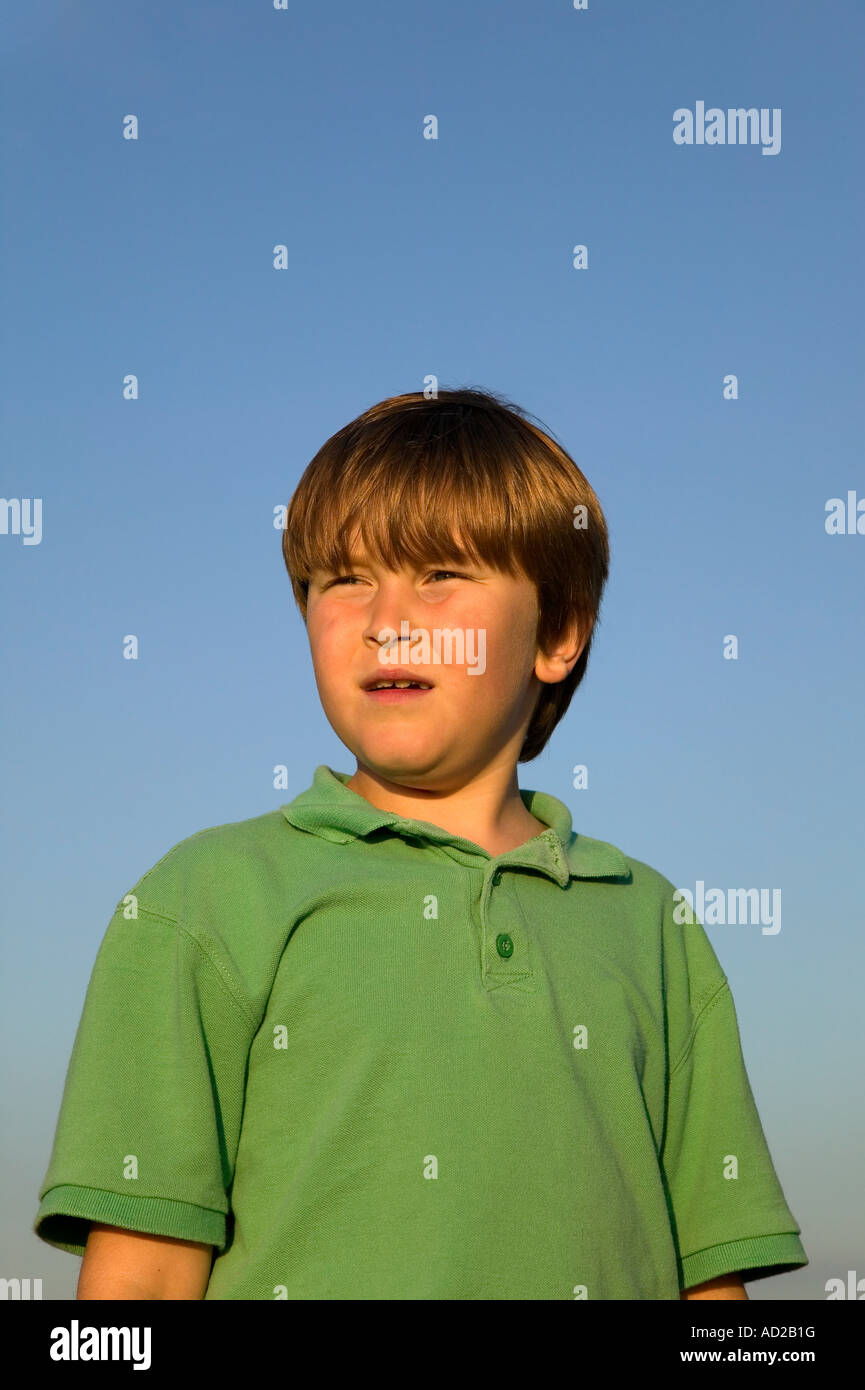 Portrait of a boy watching the sunset his face lit up by the glow Stock
