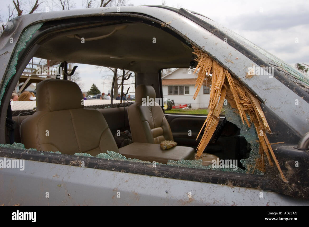 Lumber driven into the windowsill of a pickup truck by the force of a