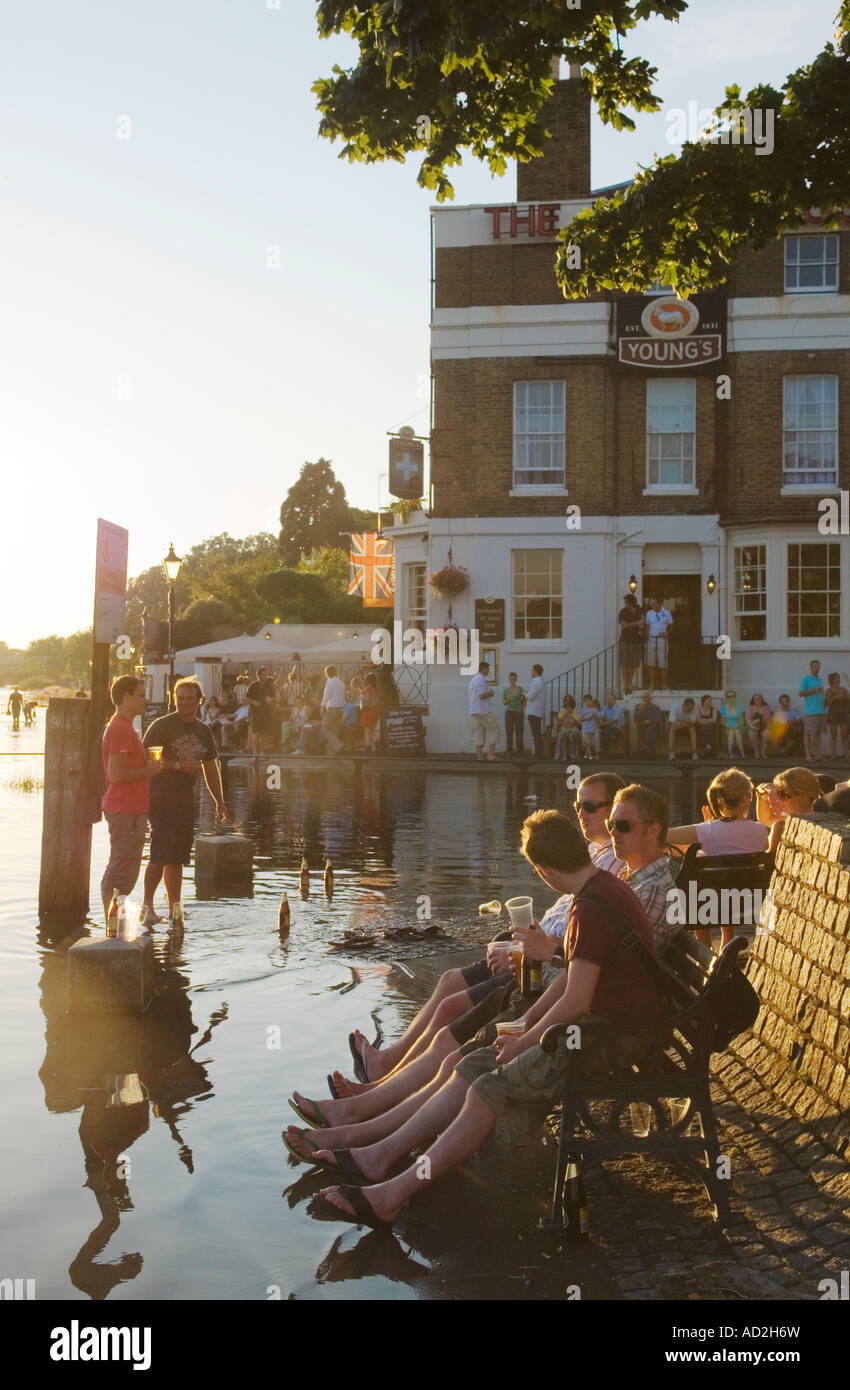 Richmond Upon Thames Surrey England  Weekend visitors enjoy a drink at high tide  HOMER SYKES Stock Photo