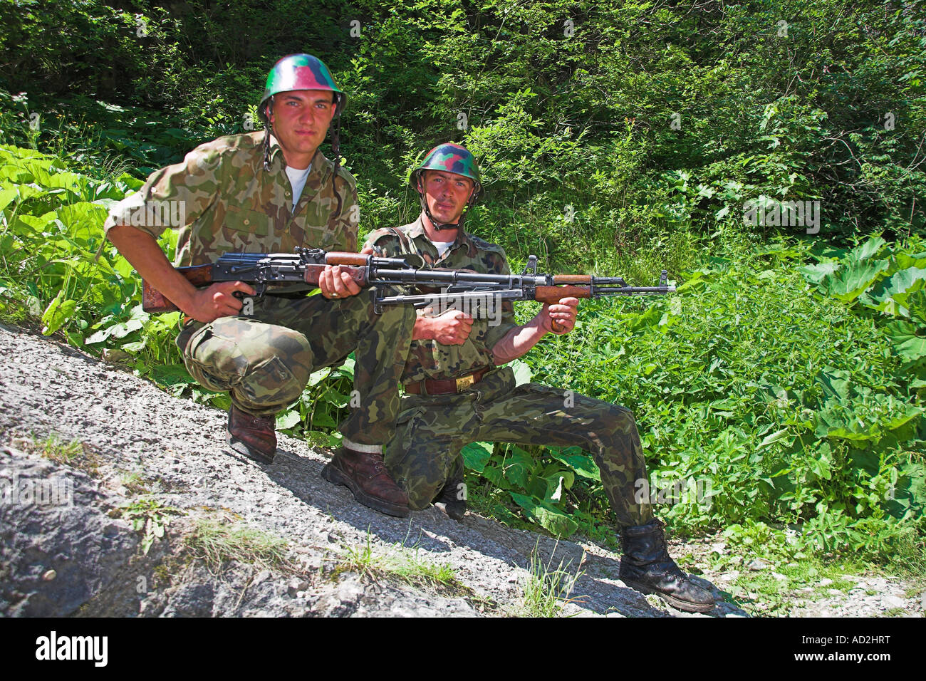 Soldiers posing with rifles, Romania Stock Photo