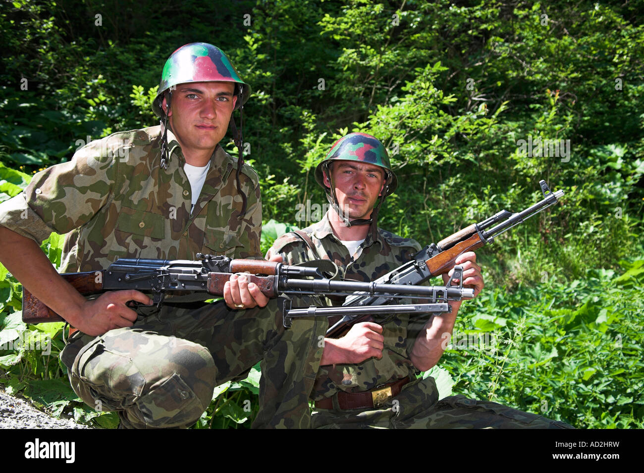 Soldiers posing with rifles, Romania Stock Photo