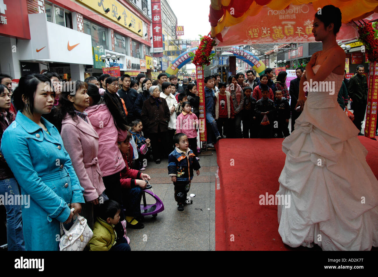 Chinese look at models displaying diamond jewellery as a promotion on a