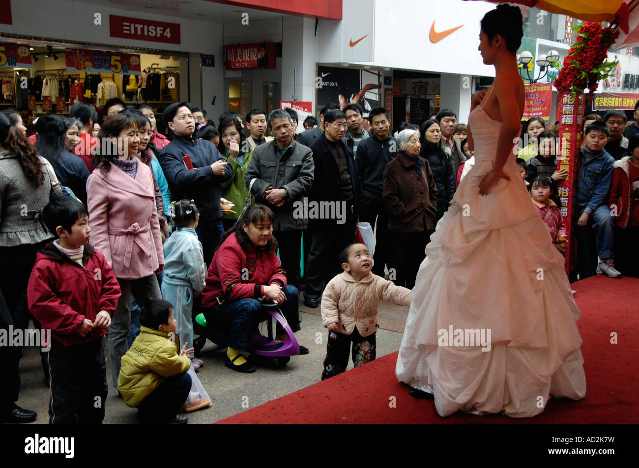 Chinese look at models displaying diamond jewellery as a promotion on a