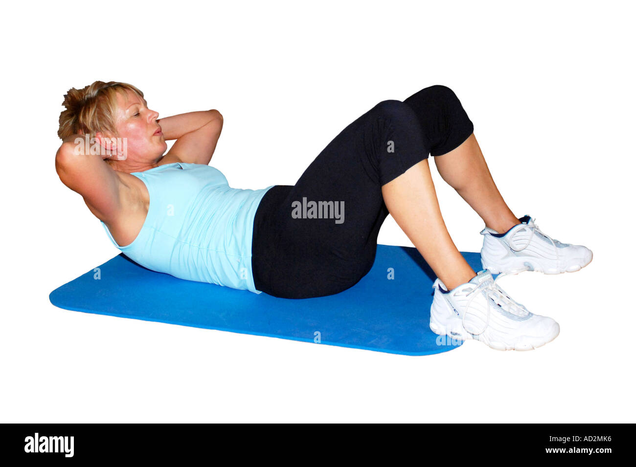 Lone adult Female performing sit ups exercise mat set against a white