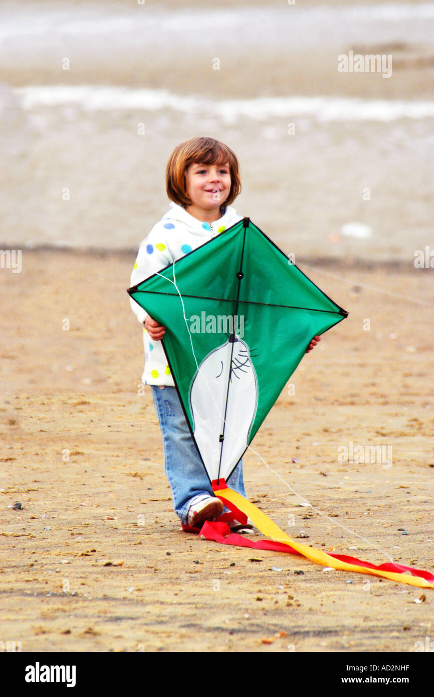 A pre-K female child holding a kite Stock Photo