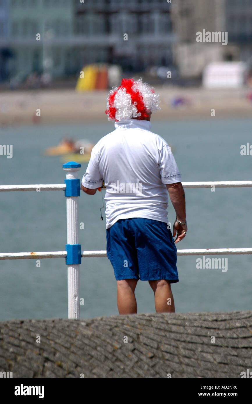 England Football supporter on vacation wearing a red and white wig. Stock Photo