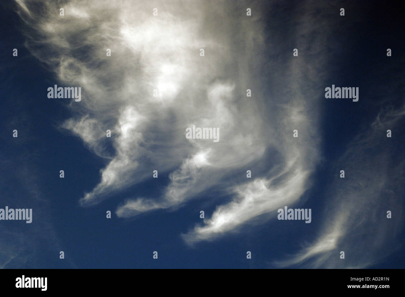 White clouds against a clear blue sky Stock Photo - Alamy