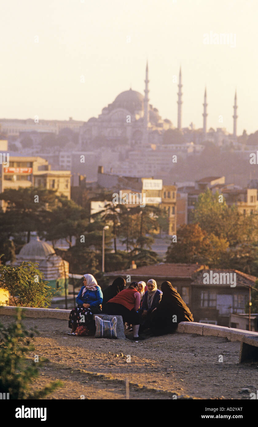 Turkey, Istanbul, Evening dusk on the hill of Galatasaray when women sit & enjoy the cool air with Mosque and Minarets in bg. Stock Photo