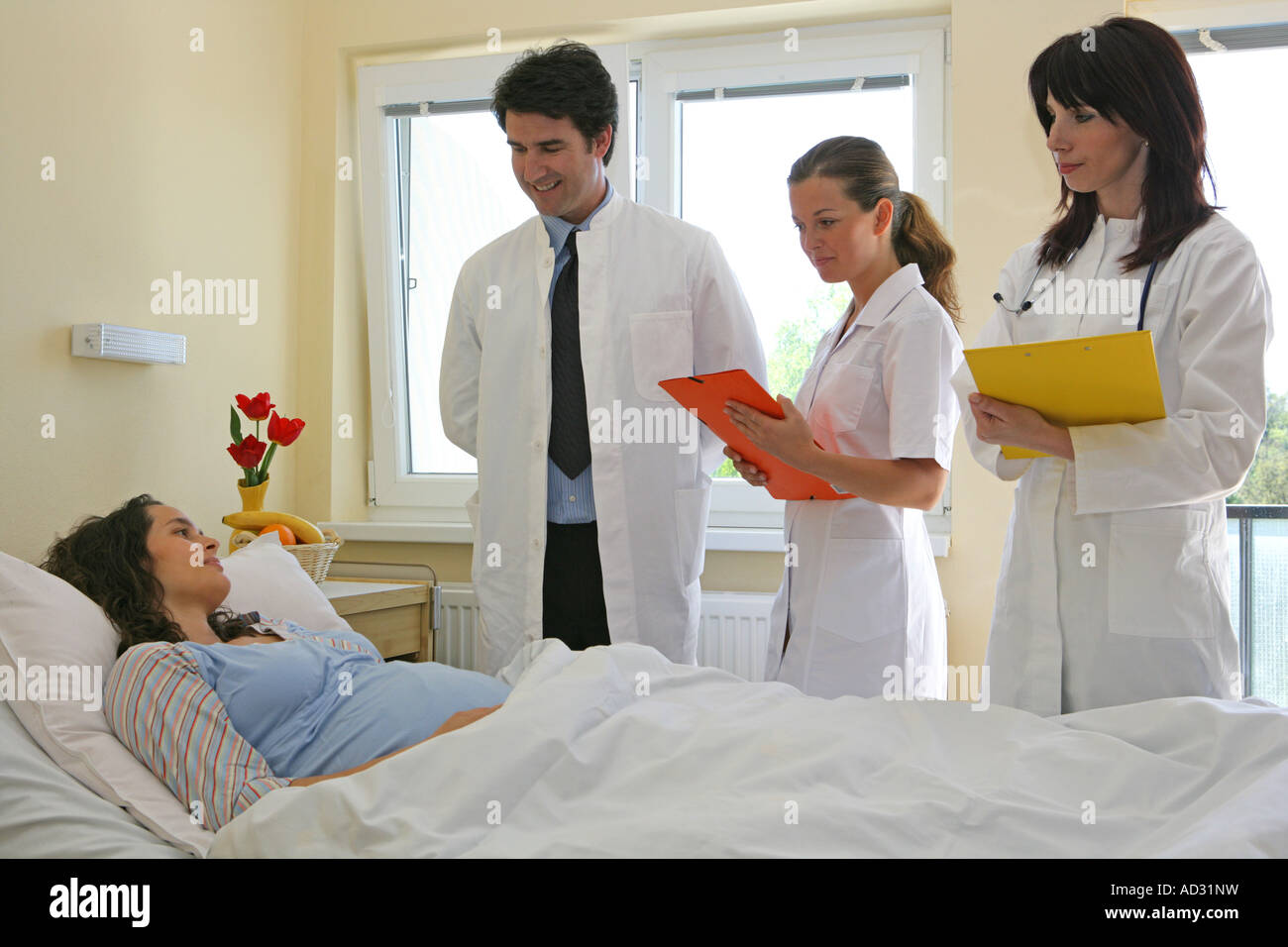 doctor checking pregnant woman lying on hospital bed Stock Photo Alamy